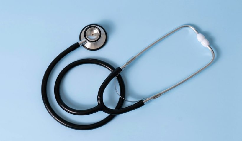 A stethoscope resting on a light blue background